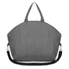 A gray fabric tote bag with handles and a shoulder strap, shown against a white background. Produktbild-Vorschau