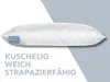 A white quilted pillow is shown on a background split between white and light gray. Text is present below the pillow. Produktbild-Vorschau