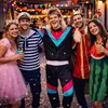 A group of four friends in costumes at a party. Anteprima dell’immagine prodotto