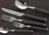 A set of cutlery laid out on a dark surface. Voir les images du produit