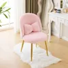 A pink fluffy chair with a bow cushion and gold legs sits on a white rug in front of a vanity table. Podgląd zdjęcia produktu