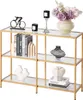 A three-tiered console table with glass shelves and a gold frame, decorated with various items. Náhľad obrázku produktu