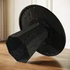 The underside of a black round dining table with a faceted pedestal base, shown on a wooden floor with a wall and curtains in the background. Produktbild-Vorschau