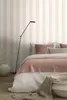 A bedroom scene with a bed, lamp, and vase. Produktbild-Vorschau