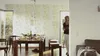 A woman walks into a dining room with a table set for a meal. Produktbild-Vorschau