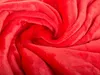 A close-up view of a red fleece blanket with a swirling pattern. Náhľad obrázku produktu