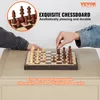Two people playing chess on a wooden chessboard. Produktbild-Vorschau