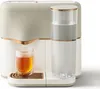 A close-up studio shot of a modern tea machine with a glass of tea. Produktbild-Vorschau