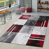 A modern living room scene with a geometric rug, side tables, and poufs. Produktbild-Vorschau