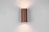 A cylindrical wall light fixture mounted on a light gray wall. Voir les images du produit
