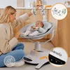 A woman is playing with a baby in a baby swing. Produktbild-Vorschau