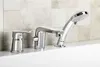 A chrome bathtub faucet with a handheld showerhead is shown installed on a white bathtub, with a tiled wall in the background. Podgląd zdjęcia produktu