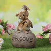 Gartenfigur Welcome - 3 Häschen auf Stein - Dekofigur - H: 26cm - Polyresin - braun Produktbild-Vorschau