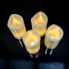 Four LED candles are arranged on a black surface. Produktbild-Vorschau