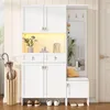 A white entryway storage unit with cabinets, drawers, a bench, a mirror, and hooks. Produktbild-Vorschau