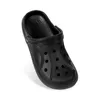 A single black clog shoe shown from a diagonal angle against a white background. Produktbild-Vorschau