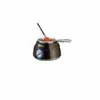 A chocolate fondue maker with a stirrer. Anteprima dell’immagine prodotto