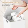 A person's hands are shown opening the lid of a white storage chest, revealing white fabric inside. Text overlays describe the product's features. Podgląd zdjęcia produktu