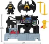 A toy Bat Command Center with accessories and a Batman figure, displayed on a white background with dimensions indicated. Podgląd zdjęcia produktu