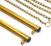 A close-up shot of two gold-colored metal poles with chains attached, against a white background. Podgląd zdjęcia produktu