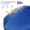 Close-up of a blue umbrella with marketing text and icons indicating sun protection and water resistance. Produktbild-Vorschau