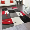 A modern living room with a white sofa and a geometric rug. Anteprima dell’immagine prodotto