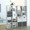 A white shelving unit filled with books, boxes, and decorative items. Náhled obrázku produktu