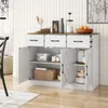 A white sideboard with a brown countertop, featuring three drawers and three cabinet doors, is shown in a room setting. The interior of the cabinets reveals storage shelves with various kitchen items. Náhľad obrázku produktu
