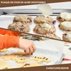 A collage showing a baking sheet with cookies and a child decorating cookies. Voir les images du produit