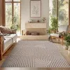 A living room with a sofa, a fireplace, and a rug. Podgląd zdjęcia produktu