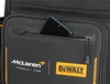 A close-up of a black bag with the McLaren and DeWalt logos, and a smartphone in a zippered pocket. Podgląd zdjęcia produktu