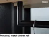 A close-up view of a black metal clothes rail attached to a wooden shelf and black vertical panels. Produktbild-Vorschau