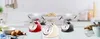 Three retro-style kitchen scales are displayed on a white wooden table in a kitchen setting. Voir les images du produit