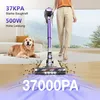 A person is using a cordless vacuum cleaner in a living room with a dog lying on the carpet. Produktbild-Vorschau