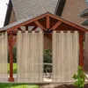 A gazebo with curtains, set up on a patio with grass in the foreground. Podgląd zdjęcia produktu