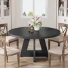 A round black dining table with four chairs in a dining room setting. Anteprima dell’immagine prodotto