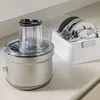 A KitchenAid Go Chopper food processor base and its accessories are displayed on a countertop. Podgląd zdjęcia produktu