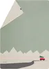 A blanket with a winter scene illustration of mountains, a road, and a red car carrying a Christmas tree. Produktbild-Vorschau