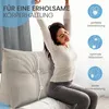 A woman is stretching on a bed next to a large wedge pillow. Produktbild-Vorschau