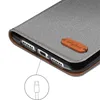 Close-up of a phone case showing the charging port and a leather tag with a logo. Produktbild-Vorschau