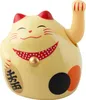 A close-up studio shot of a decorative lucky cat figurine. Produktbild-Vorschau