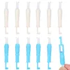 A collection of plastic needle threaders, some white and some blue, arranged in two rows on a white background. Produktbild-Vorschau