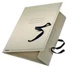 A beige folder with black ribbon ties, shown at an angle against a white background. Náhled obrázku produktu