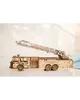 A wooden model fire truck with an extended ladder, displayed on a light-colored surface. Produktbild-Vorschau