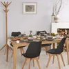 A dining room scene with a wooden table set for a meal, surrounded by black chairs. A fireplace with stacked logs is visible in the background. Náhled obrázku produktu
