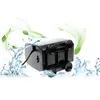 A black submersible water pump is shown from an underneath angle, with water splashing around it and green leaves and swirls in the background. Podgląd zdjęcia produktu