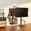 A TV stand with a TV mounted on it, shown in a living room setting with a chest of drawers and a lamp. Anteprima dell’immagine prodotto