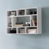 A white modular wall shelf mounted on a light blue wall, filled with various decorative items and books. Náhled obrázku produktu
