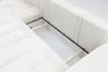 A close-up view of the interior storage compartment of a beige sectional sofa. Náhľad obrázku produktu