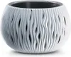 A white, decorative plant pot with a wavy, perforated design. Podgląd zdjęcia produktu